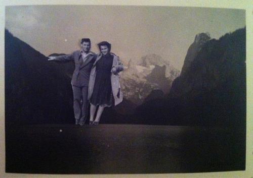 Image of a rocky mountain landscape, and a collaged couple leaning on one of the mountains.