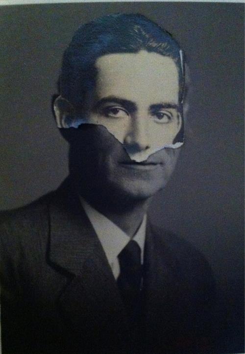 Portrait of a man, and a ripped face of a different man laid over the original portrait, appearing like the man is wearing the mask of another.